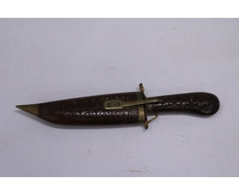 A VINTAGE IDIAN WOOD AND BRASS KNIFE IN A HAND CARVED WOODEN SHEATH APPROXIMATLEY - 21CM 