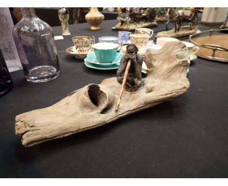 Australian ceramic aboriginal with digeridoo on a driftwood base L: 38 cm   CONDITION REPORT:  No breaks or apparent losses. 
