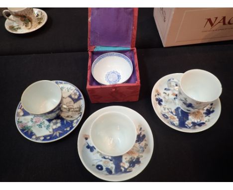 Chinese tea bowl cup and saucer and Nanking Cargo pair of teacups with elaborate loop handle and saucers with blue Chrysanthe