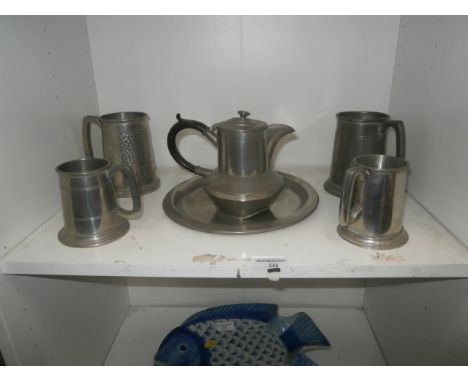 shelf of pewter inc tea pot and tankards