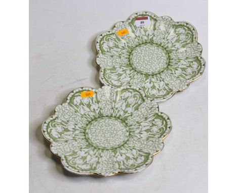 A pair of late Victorian Foley China plates, each of scalloped shape, on a green ground with floral decoration, having entwin
