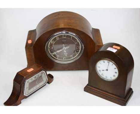 An Edwardian mahogany cased dome topped mantel clock, having a circular enamelled dial with Roman numerals and cylinder movem