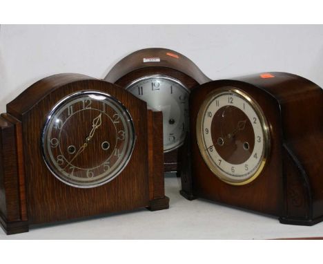 A 1930s oak cased mantel clock having a silvered dial with 8-day movement striking on a gong, height 23cm, together with two 