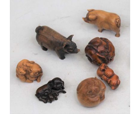 A reproduction boxwood netsuke, carved as a sow, length 7cm; together with various other reproduction carved boxwood netsuke;
