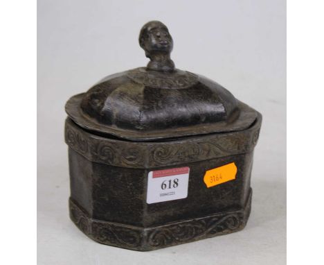 A 19th century lead tea caddy, the lid with head finial 14cm high