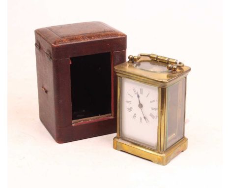 An early 20th century lacquered brass cased carriage clock, having an enamelled dial with Roman numerals, visible platform le