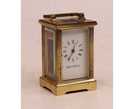 An early 20th century miniature lacquered brass cased carriage clock, having an enamelled dial with Arabic numerals signed Ma