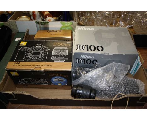 A box containing a Nikon D100 boxed camera, a Nikon D50 boxed camera, Nikon 70-300 boxed lens, Nikon 16-85 lens, Nikon 18-55 