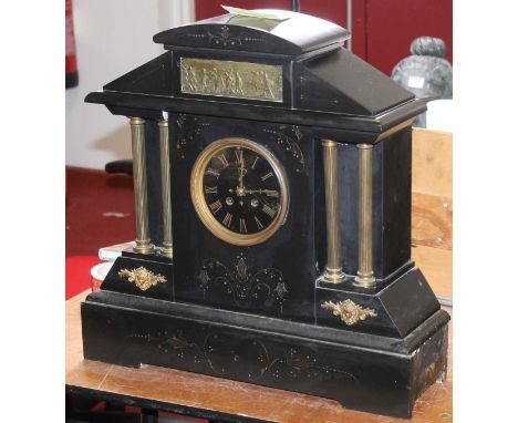 A large late Victorian black slate mantel clock of architectural form, having a black dial with gilt Roman numerals and eight