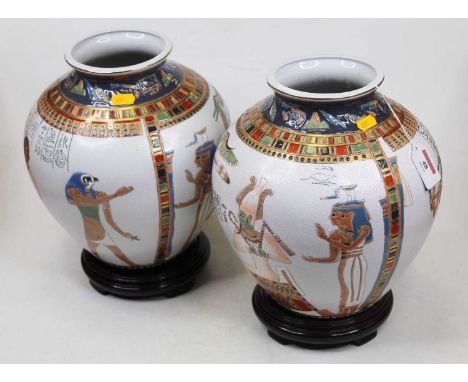 A pair of modern Egyptian style vases, each of squat circular form, on a white ground, incised and enamel decorated with Egyp