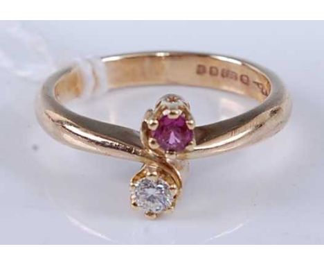 A modern 9ct gold ruby and diamond crossover ring, each round cut stone weighing approx 0.12ct, 3.5g, size M