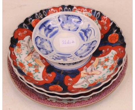 An early 19th century Chinese export tin-glazed plate, enamel decorated with roses within pink floral border, dia.23cm; toget