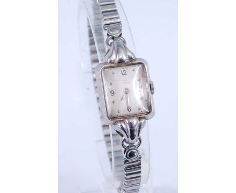 An Art Deco lady's Omega steel cased wristwatch, having a signed silvered rectangular dial with proud single lugs, manual win