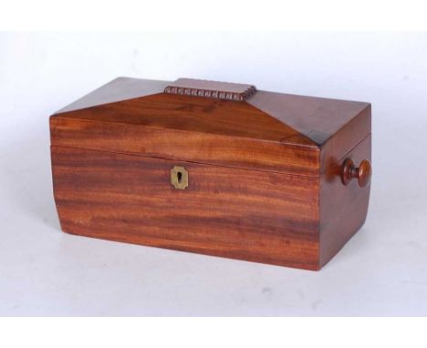 A Regency mahogany tea caddy, of sarcophagus form, having inlaid brass escutcheon and flanked by turned carry handles, the li