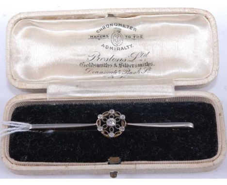 An Art Deco yellow metal platinum faced and diamond set bar brooch, arranged as 7 old cuts, the centre stone weighing approx 