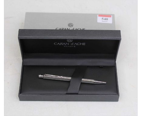 A Caran d'Ache engine turned ballpoint pen, boxed and in card outer sleeve 