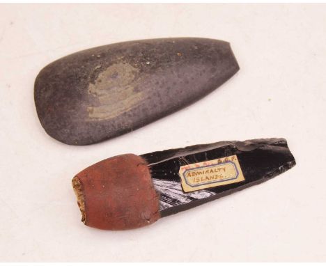 A flint axe head or spear tip, bearing hand-written label for Admiralty Island, length 12cm; together with one other stone ax