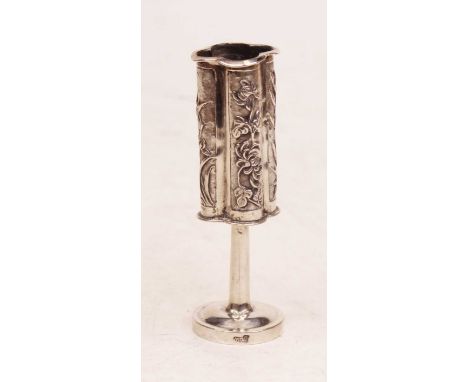 An early 20th century Chinese silver taper holder, of quatraform, embossed with flowers and bamboo, h.10cm