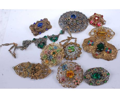 A collection of gilt metal paste and enamel set brooches