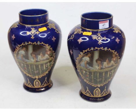 A pair of early 20th century vases, each of baluster form, on a blue ground printed with four maidens upon a balcony, having 