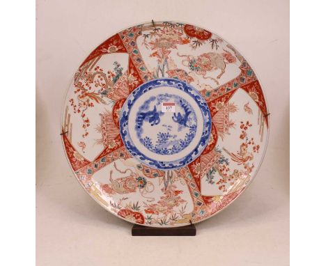 A large Japanese Meiji period (1868-1912) charger of circular form, the centre underglaze blue decorated with flowers within 