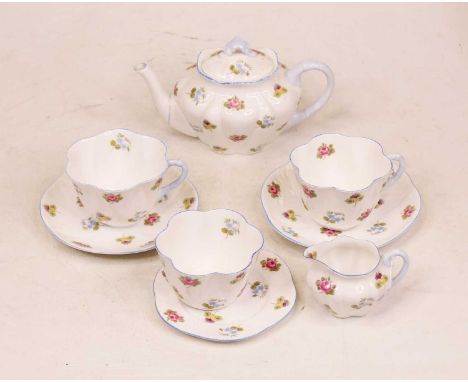 An early 20th century Shelley tete-a-tete tea service, decorated in the Rose, Pansy &amp; Forget-me-not pattern, having print