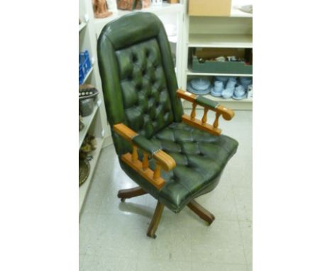 A modern beech framed open arm desk chair, button upholstered in green hide, rotating on splayed legs and casters       CA