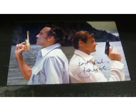 A photograph of Roger Moore and Christopher Lee 'The Man with the Golden Gun'  bearing an autograph, in a card mount        O