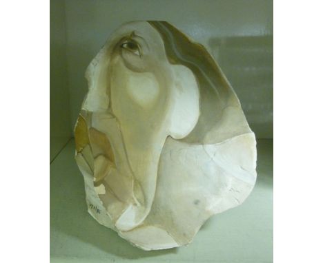 A rock painted with a portrait, a woman's head  bears indistinct signature & dated '86  8.5''h       OS1