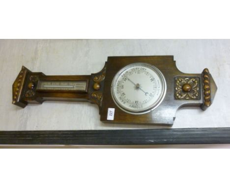 A 1930s oak framed barometer, having a silvered dial and a thermometer  28''h         BSR