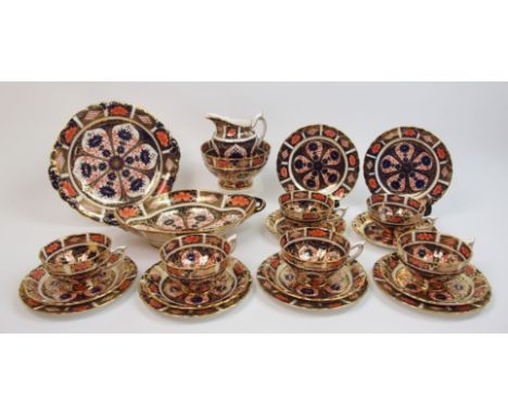 A Royal Crown Derby Imari pattern tea service comprising six cups, saucers, plates, milk jug, sugar bowl, cake plate and dish