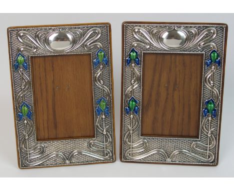 A matched pair of Art Nouveau silver mounted photo frames one by S Blanckensee & Sons, Chester 1909, the other by Hart & Sons