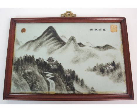 A Chinese rectangular porcelain tile painted with pagodas in a mountainous landscape, within hardwood frame, signed, with Sha