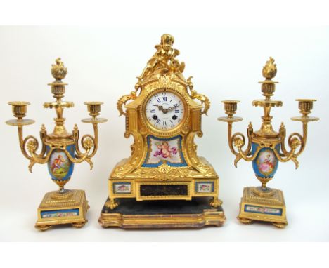 A French gilt metal and porcelain clock garniture by Gantier, Paris the Sevres style turquoise porcelain, painted with figure