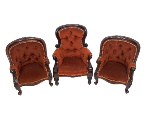 Three Victorian style stained scroll button back child's armchairs comprising; a pair with foliate capped legs and another wi
