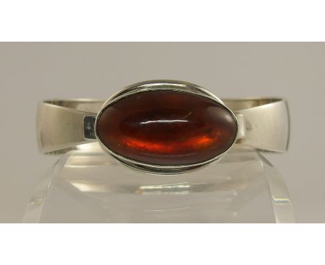 A silver amber coloured stone set Danish bangle by FROM with a simple sprung closure the back of the bangle is stamped Sterli