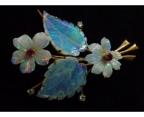 An 18ct gold carved opal flower brooch with carved white opal flowers and blue jelly opal leaves further set with diamonds an