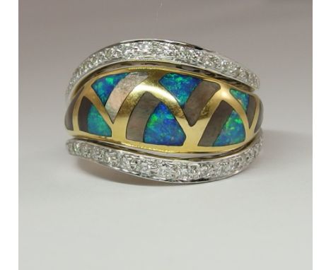 An 18ct gold dress ring inlaid with opal, mother of pearl and diamonds estimates approx weight of diamonds 0.50cts, finger si