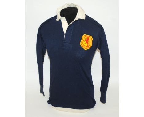 A blue Scotland v. Wales International shirt with button-up collar and embroidered cloth badge inscribed S v W, 1936-1937 The