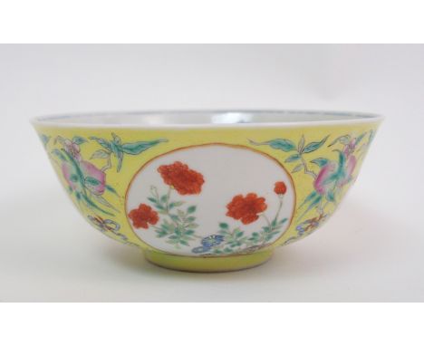 A Chinese yellow ground medallion bowl the exterior with four circular panels painted with various flowers divided by ribbon 