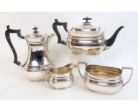 A four piece silver tea service by R & W Sorley, London 1923, of rounded rectangular form with raised banding on plinth base,