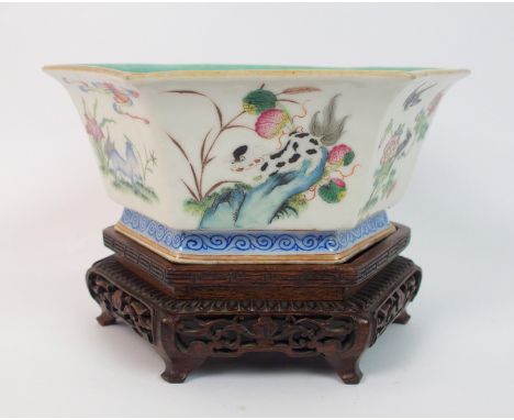 A Chinese hexagonal bowl the exterior painted with panels of buddhistic lions, birds, butterflies, flowers and foliage above 