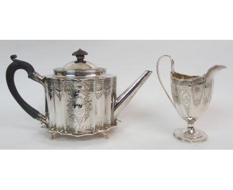 A George III silver teapot possibly by John Robins, London, 1795, of oval outline with serpentine-shaped sides, having banded