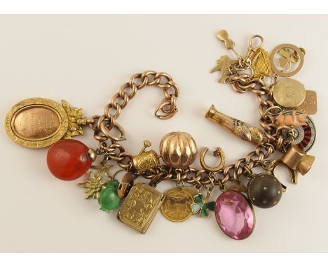 A 9ct gold charm bracelet hung with a good collection of charms in gold, white metal and yellow metal to include a Victorian 
