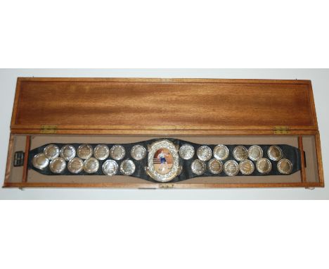 A silver and enamel Reg King Challenge Belt the leather belt bearing twenty-four various silver or white-metal circular plaqu