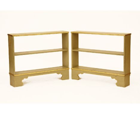 A pair of modern dwarf open bookcases, painted light green with gilt details, 69cm high