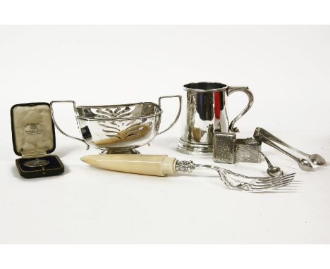 A silver tankard, a vesta with a shield cartouche and initials 'T.W. 1910', a pierced basket, tongs, a napkin ring, a souveni