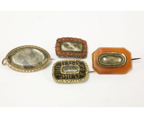 Four memorial brooches, to include a gold black enamel with gilt monogram memorial brooch, locket and plaited hair to centre,