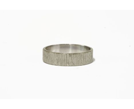 An 18ct white gold bark textured wedding ring, by Slade & Woolf, London, 1967, finger size M4.10g