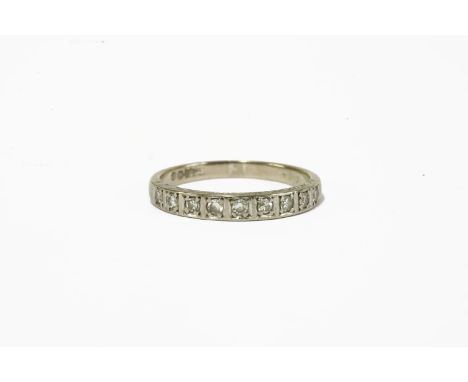 A white gold diamond half eternity ring, marked 18ct